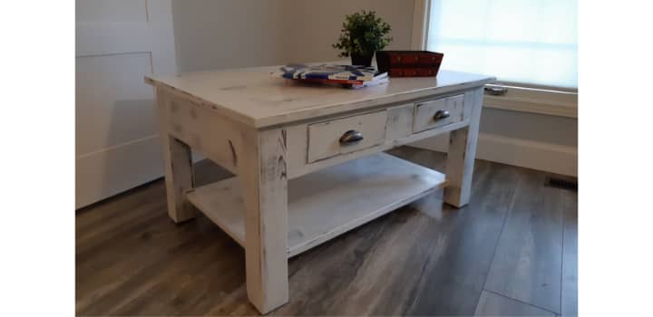 Completed antique white coffee table with all hardware attached 