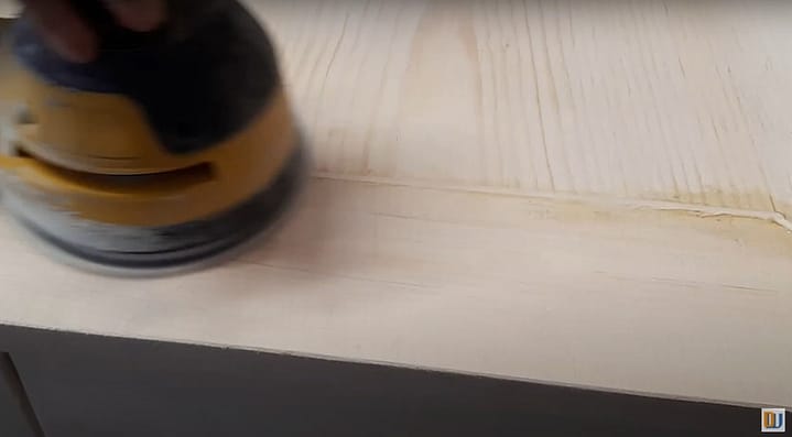 sanding the wooden spline to the top of the table